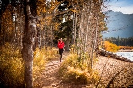 Woman running on beach next to Lake Tahoe.