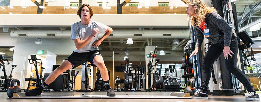 Athlete training on slide board.