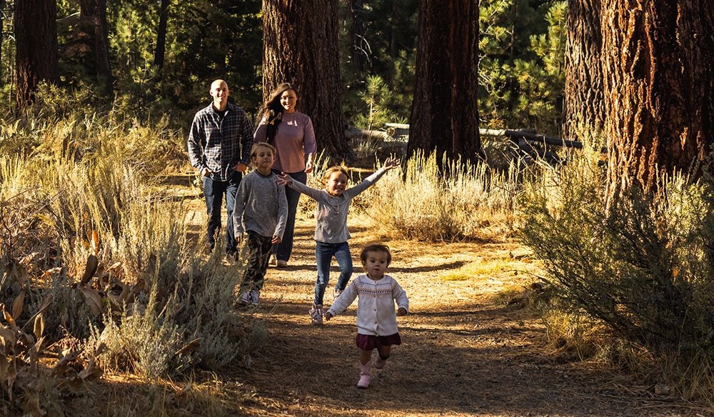 A family walks through the forest in Lake Tahoe.