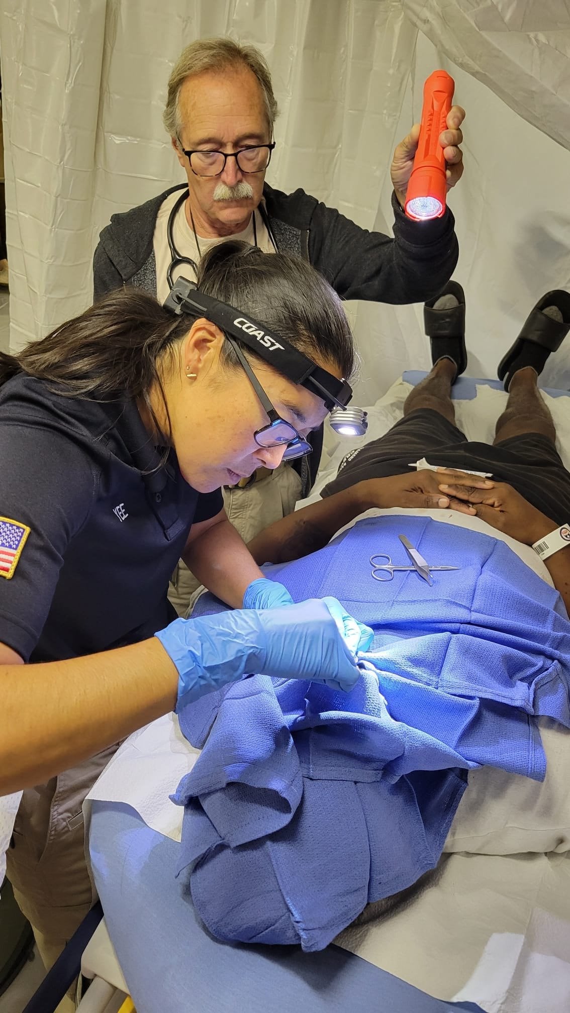 Dr. Kandra Yee attends a patient with a head injury.