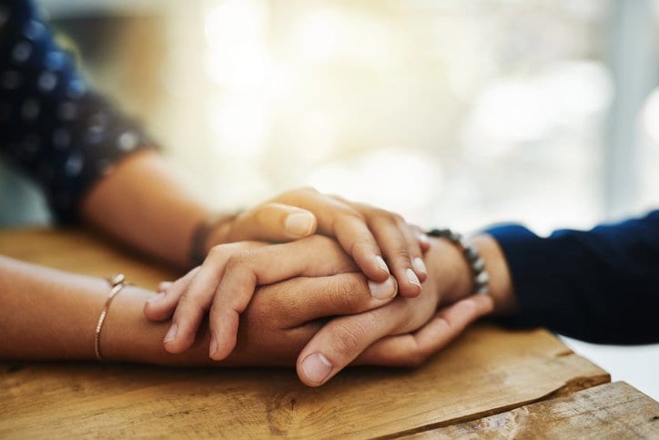 Two people holding hands