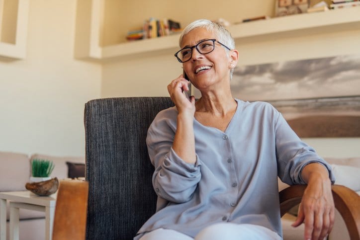 A person talks on a phone.